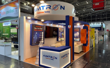 Turnkey trade show display for AIMTRON by Expo Creators with modern fabrication, LED signage, and a curved standout design.