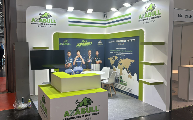 AXBULL booth by Expo Creators with custom white-green design, graphics printing, shelving, and branding for trade expos.