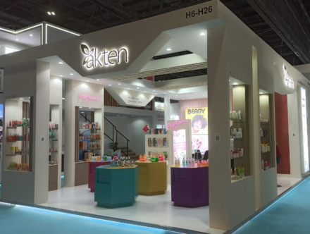 Trade Show Booth Design-expocreators, akten booth by Expo Creators with vibrant displays, detailed fabrication, colorful product showcasing, and turnkey design.
